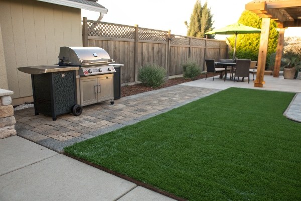 image placeholder for a barbecue set up safely on a patio next to artificial grass