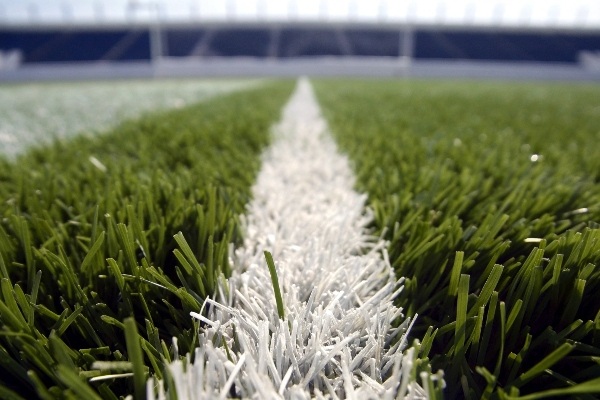 Close-up shot of artificial turf fibers for football