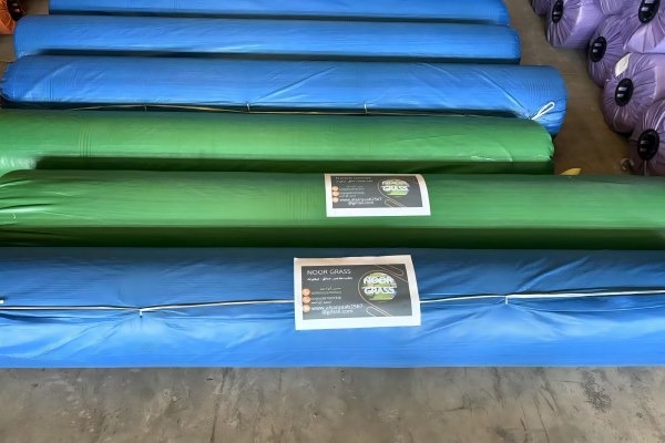 Organized warehouse with color-coded turf rolls