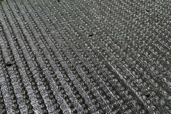 Close-up showing the smooth texture of PU backing on an artificial turf roll