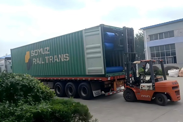 A roll of artificial grass ready for shipping in a warehouse