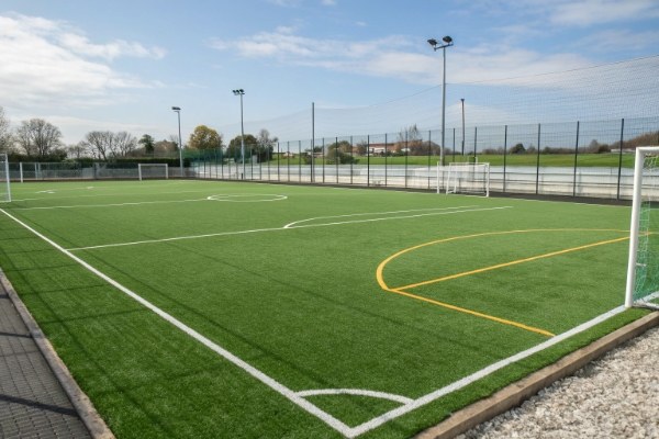 A perfectly sized mini football field with green artificial turf