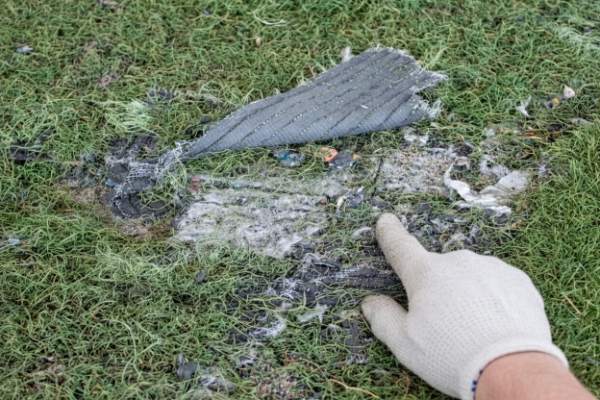 damaged artificial grass backing inspection