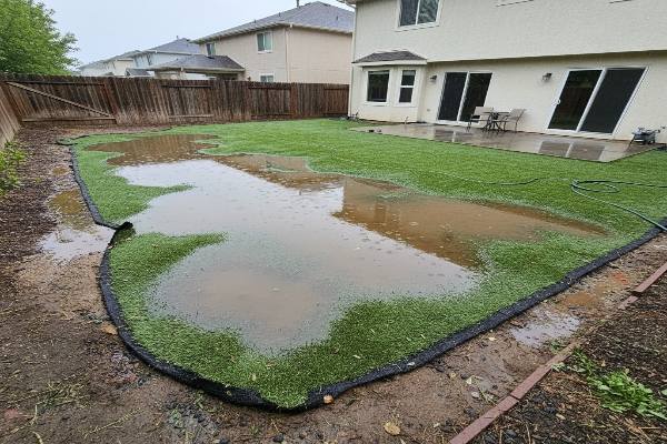 Example of a poorly installed artificial turf area with water pooling