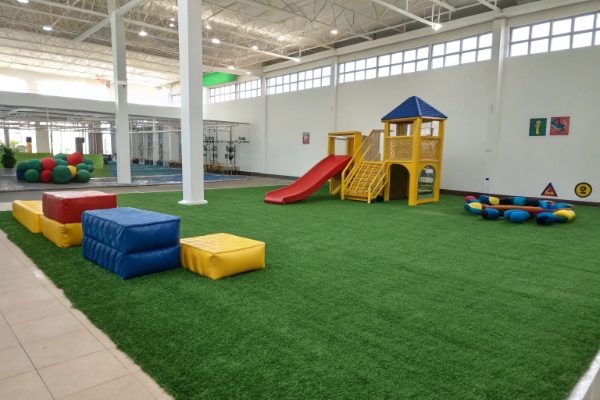 Indoor playground with artificial grass, slide, soft blocks