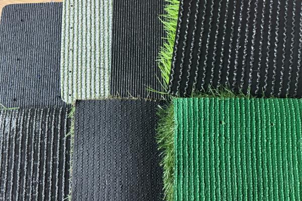 Close up of artificial grass backing showing glue quality