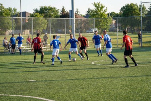 artificial football turf field with players
