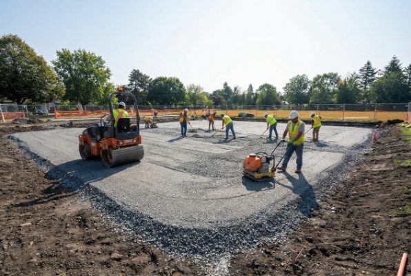 compacting base material with vibratory roller