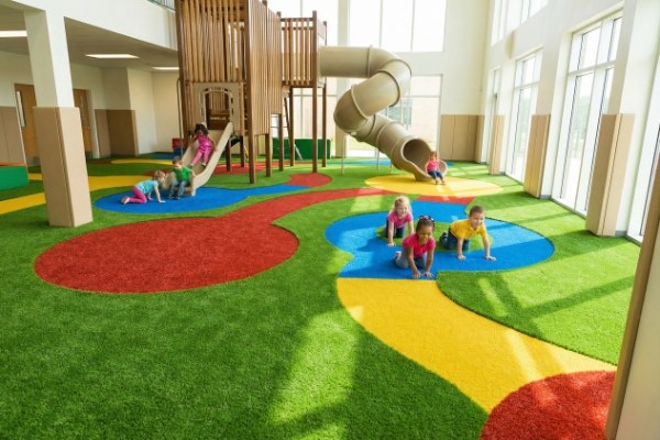 How can indoor artificial grass be used in playgrounds
