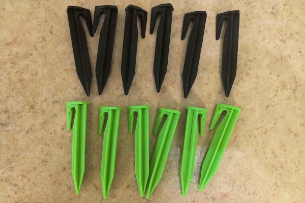 Green PE U-nails used to anchor hybrid turf securely to the ground